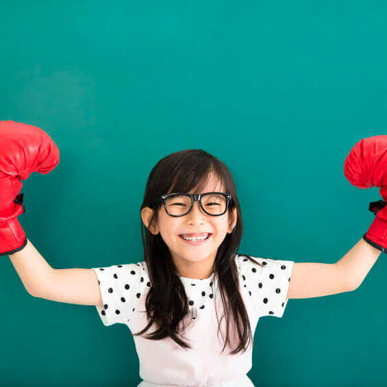 49363955 - happy little girl with red boxing gloves before chalkboard